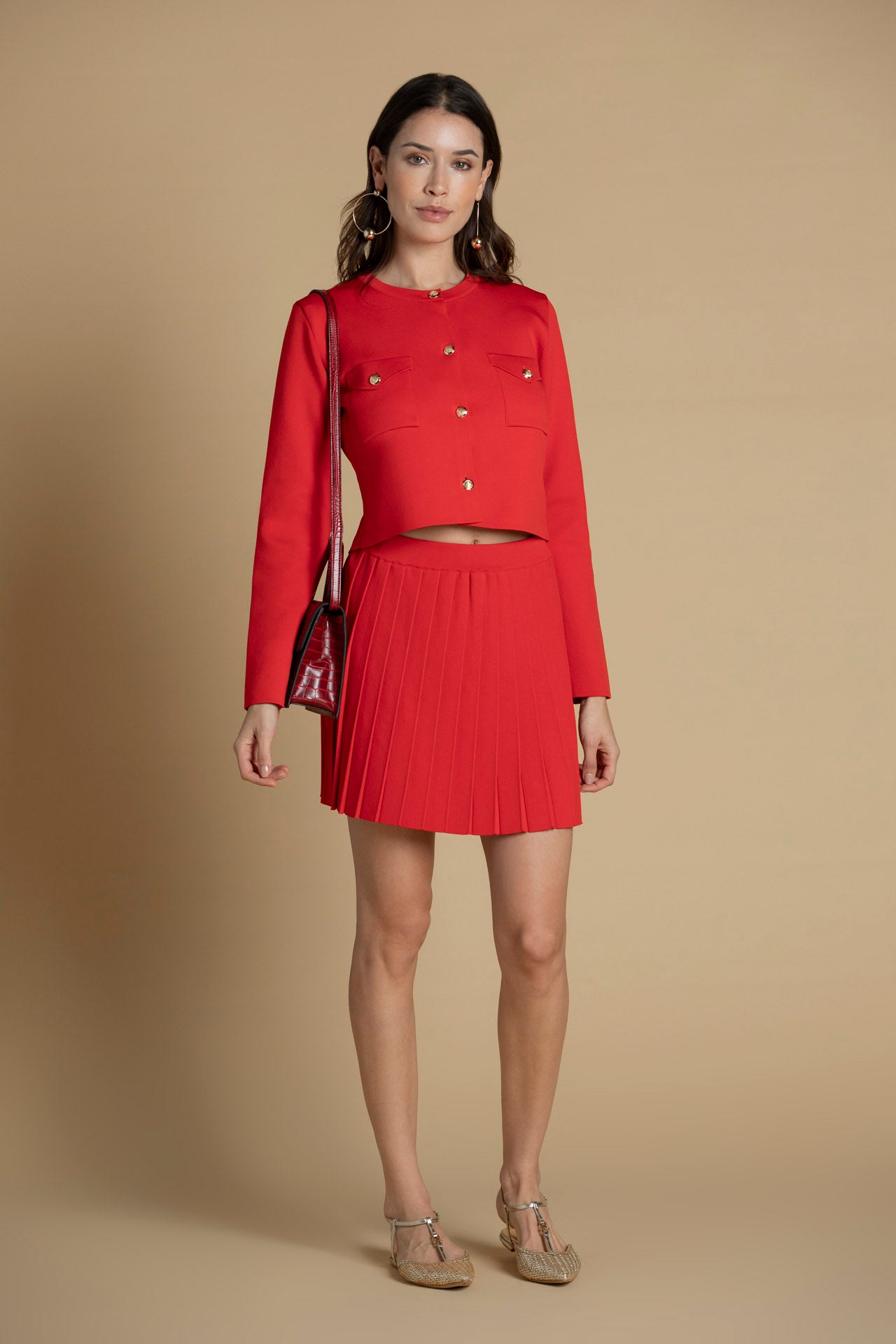 Casaco de malha com botões dourados