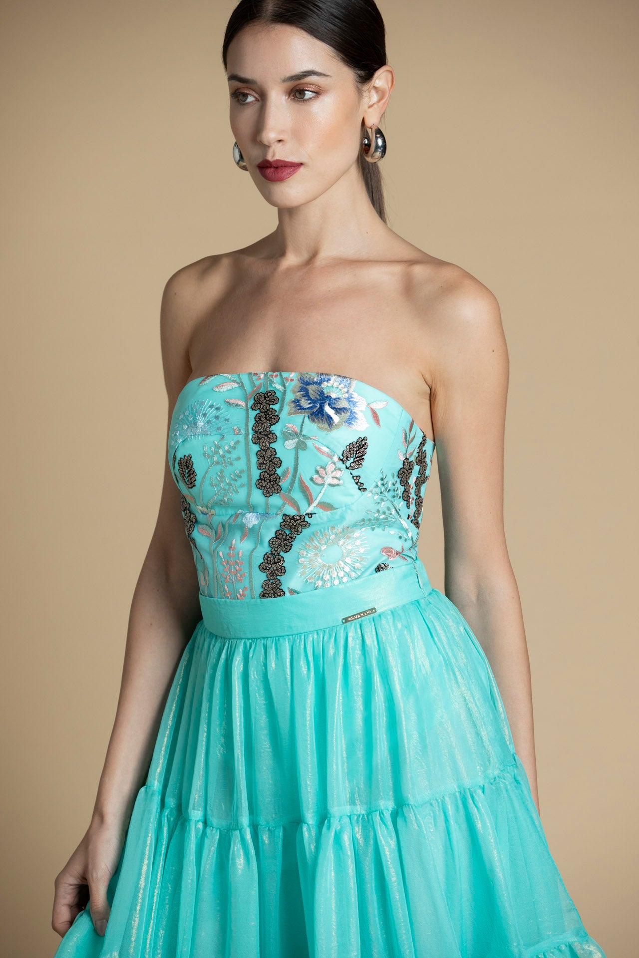 Vista frontal do body com bordado de missangas e decote reto.